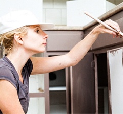 woman painting cabinets