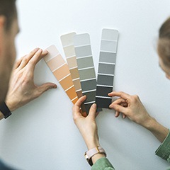 people selecting a paint color for an interior wall