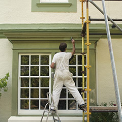 Team painting outside of home