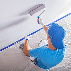 Painter painting inside of home