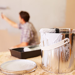 Person painting interior walls