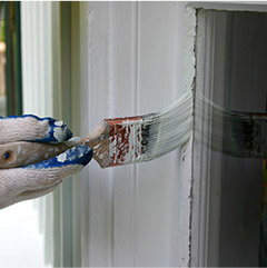 Closeup of person painting outside of home