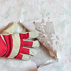 Closeup of team member removing wallpaper