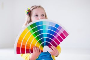 child deciding on colors for painting a child’s room