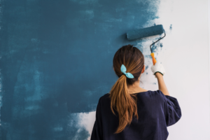 a woman painting the interior of her home