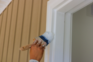 a person painting an interior wall 