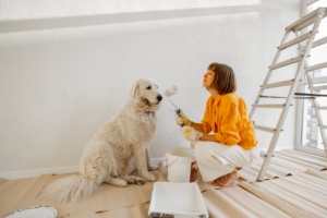a woman and her dog with paint supplies